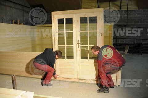 Log cabins door being slotted into the wall